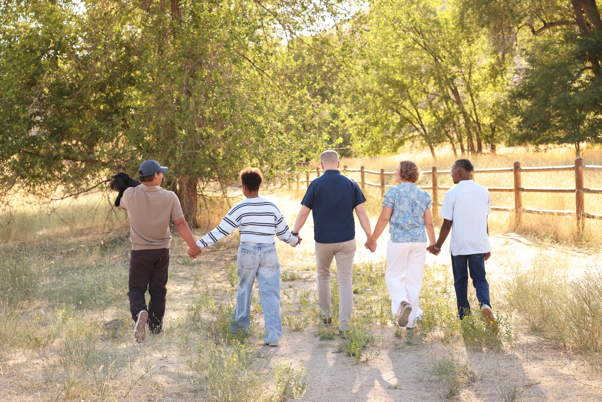 Cacey Klein walking with her family along a sunlit trail in Idaho.